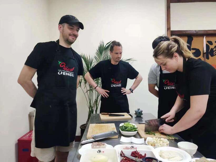 Chengdu: Cooking Class with Fresh Market Half Day Experience - Learning Sichuan dishes at the wok