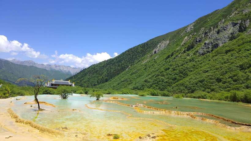 Huanglong Scenic Area: Explore Stunning Five-Colored Ponds - Golden Sand Pavement and the travertine terraces