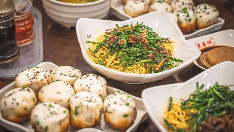 Shanghai: Evening Walking Food Tour - Shanghai’s carb course, from scallion noodles to pan-fried buns